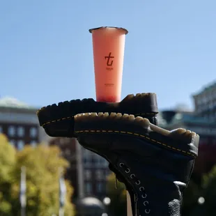 a hand holding a cup of coffee