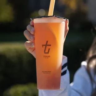 a person holding a drink