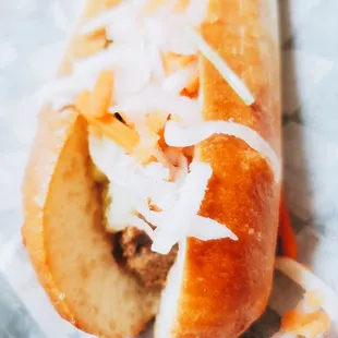 a hot dog with cheese and coleslaw