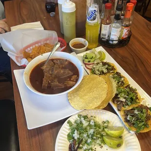 Posole care asada tacos, guacamole sauce, And two types of hot sauce, All homemade.