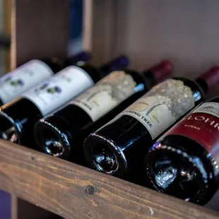 a shelf of wine bottles