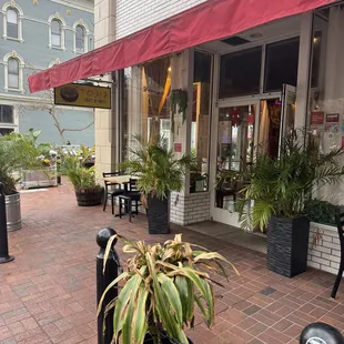 a restaurant with a red awning