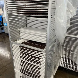 a stack of trays on a cart