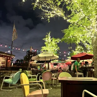 tables and chairs under a tree