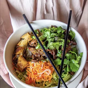 a person holding a bowl of food