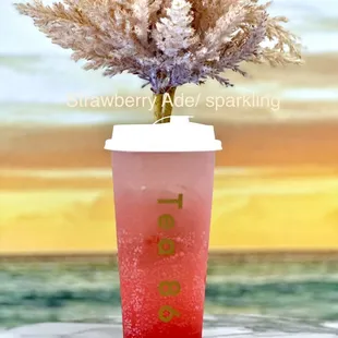 a cup with a plant in it