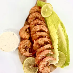 grilled shrimp and lettuce on a cutting board