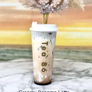 a coffee cup with a plant in it