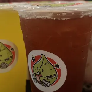 a woman sitting at a table with two cups of tea