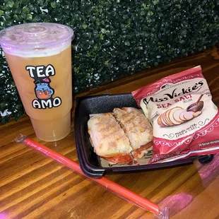 Combo with tea and Pizzanini sandwich with chips.