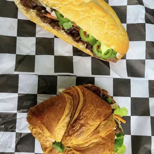 two sandwiches on a checkered tablecloth