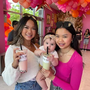two women holding a baby
