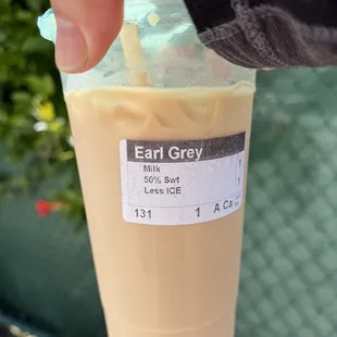 a hand holding a cup of iced coffee