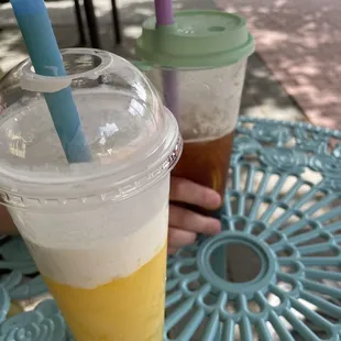 a hand holding a cup of iced tea