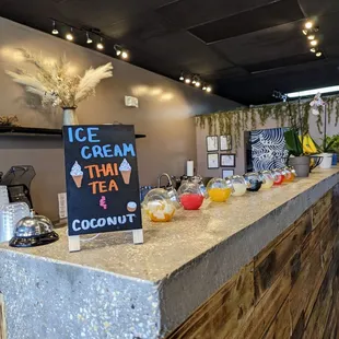 Counter with different boba jelly and popping boba in a jar