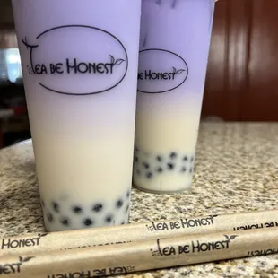 two cups of tea and a straw