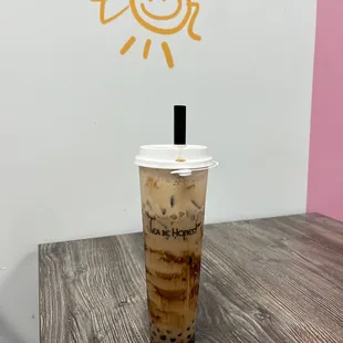 a cup of iced coffee on a table