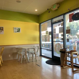 tables and chairs in front of a window