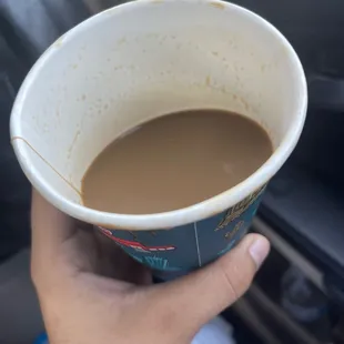 a person holding a cup of coffee