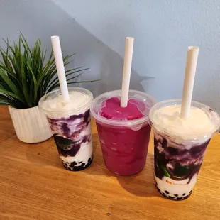 three cups of different flavored drinks