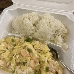 a take out container with rice and shrimp