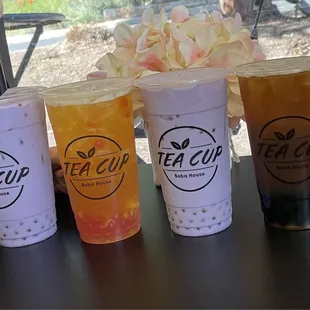 Taro milk tea with popping boba, fruit tea with popping boba, taro milk tea with popping boba and oolong with tapioca pearls