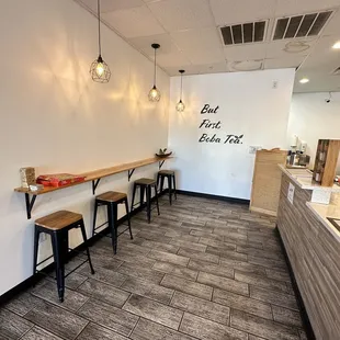 a cafe with a long counter and stools
