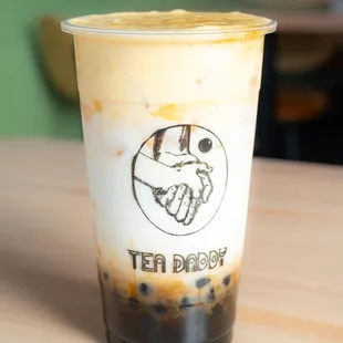 a cup of iced coffee on a table