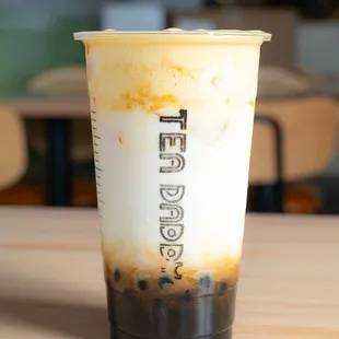 a cup of iced coffee on a table