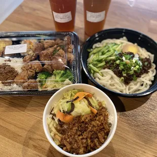 a bowl of noodles, a bowl of meat and a cup of beer