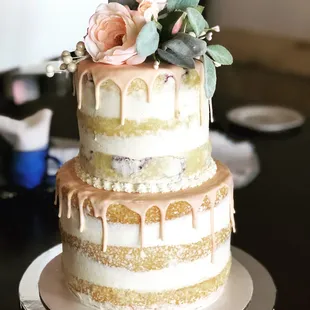 a three tiered cake with flowers on top
