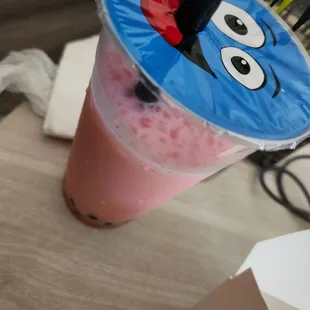 Strawberry boba tea over ice.