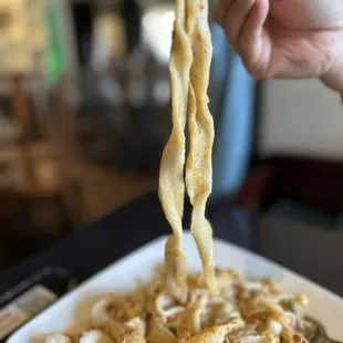 Scalded chili noodles - wide hand stretched noodles