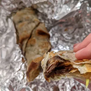 a hand holding a piece of food