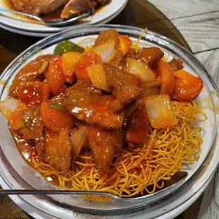 Tomato beef chow mein with crispy noodles
