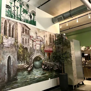 a mural of a canal in a coffee shop