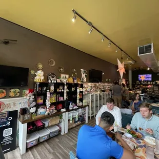 ople sitting at tables in a store