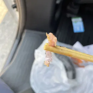 person holding a chopstick in their hand