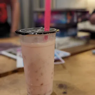 a pink drink with a straw