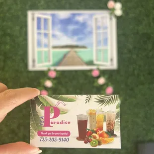 a hand holding a business card