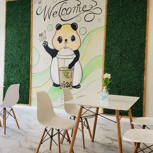 a panda bear with a cup of tea