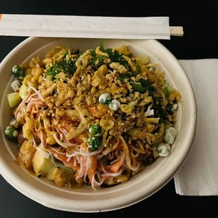 a bowl of food with chopsticks