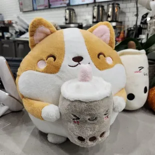 a stuffed animal holding a cup of tea