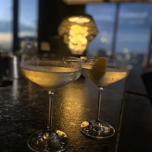 two glasses of champagne on a bar