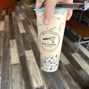 a hand holding a spoon