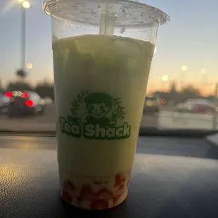 Honey dew milk tea with coconut powder and strawberry jelly
