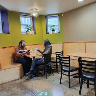 two people sitting at a table in a restaurant