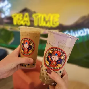 two people toasting their drinks