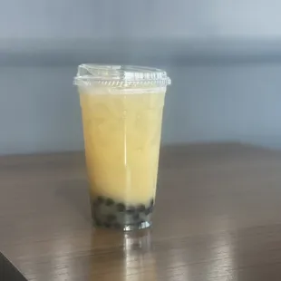 a glass of bubble tea on a table