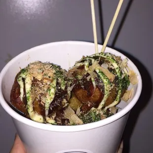 takoyaki! a popular Japanese street food. fried octopus balls drizzled w tako. sauce &amp; mayo. seaweed &amp; bonito flakes are sprinkled on top!